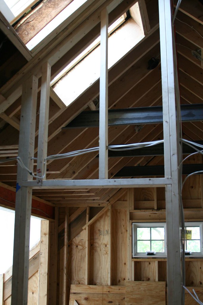 Professional sun tunnel skylight installation showing natural light streaming through attic window